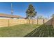 Fenced backyard space with a well-maintained lawn offers a secure and private outdoor area at 3201 Albion St, Denver, CO 80207