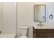 This bathroom features modern fixtures including a gold faucet and wood vanity at 3201 Albion St, Denver, CO 80207