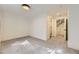 Bedroom with neutral carpet with ensuite bathroom and access to stairs at 3201 Albion St, Denver, CO 80207