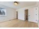 Bedroom with hardwood floors, natural light, and ensuite bath and closet at 3201 Albion St, Denver, CO 80207