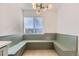Cozy dining nook with custom built in bench seating and modern light fixture at 3201 Albion St, Denver, CO 80207