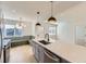 Open kitchen with an island featuring quartz countertops and dining nook at 3201 Albion St, Denver, CO 80207