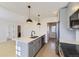 Open kitchen with quartz countertops and stainless steel appliances at 3201 Albion St, Denver, CO 80207