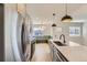 Bright kitchen includes stainless steel appliances, modern counters, and built-in breakfast nook at 3201 Albion St, Denver, CO 80207