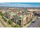 Aerial view of the complex highlighting multiple buildings, parking, landscaping and surrounding neighborhood at 1044 Rockhurst Dr # 401, Highlands Ranch, CO 80129