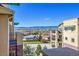 Scenic balcony view showcasing residential buildings and distant mountain views against a clear blue sky at 1044 Rockhurst Dr # 401, Highlands Ranch, CO 80129