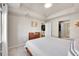 Cozy bedroom with soft carpet, featuring a wooden dresser and glimpses into the kitchen and bathroom at 1044 Rockhurst Dr # 401, Highlands Ranch, CO 80129