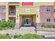 Inviting entrance with brick accents, prominent building number, and well-maintained landscaping at 1044 Rockhurst Dr # 401, Highlands Ranch, CO 80129
