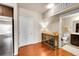 Inviting entryway with hardwood floors, console table, and a view of the adjacent bathroom at 1044 Rockhurst Dr # 401, Highlands Ranch, CO 80129