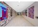 Long hallway adorned with artwork and stylish lighting, leading to various units at 1044 Rockhurst Dr # 401, Highlands Ranch, CO 80129