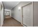 Apartment 401, long hallway with carpet, leading to various units in the building at 1044 Rockhurst Dr # 401, Highlands Ranch, CO 80129