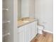 Modern bathroom boasts granite countertop, white cabinets, shelving, and wood look flooring, creating a spa-like experience at 819 Sunflower Dr, Brighton, CO 80601