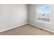 A cozy bedroom features neutral walls, carpet, and a window with a view of snowy landscape at 819 Sunflower Dr, Brighton, CO 80601