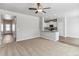 Open living room area with carpeted floors and fan overlooking the gourmet kitchen with stainless steel appliances at 819 Sunflower Dr, Brighton, CO 80601