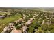 An aerial view shows a community, a golf course, mature trees and some homes at 2535 W 115Th Dr, Westminster, CO 80234