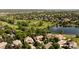 Aerial view of homes and golf course, surrounded by lush green trees and a lake at 2535 W 115Th Dr, Westminster, CO 80234