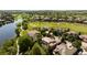 Aerial shot of a residential area featuring lush greenery, a lake, and a golf course at 2535 W 115Th Dr, Westminster, CO 80234