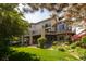 Large home featuring an expansive backyard with lush landscaping, patios, and manicured lawns at 2535 W 115Th Dr, Westminster, CO 80234