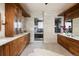 Luxurious bathroom featuring double vanity, custom cabinetry, stone walls, and tiled floors at 2535 W 115Th Dr, Westminster, CO 80234