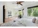 Bright bedroom with hardwood floors, ceiling fan, and views of the outside trees from the bay window at 2535 W 115Th Dr, Westminster, CO 80234