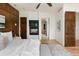Bedroom featuring hardwood floors, a TV over a fireplace, and natural wood accents at 2535 W 115Th Dr, Westminster, CO 80234