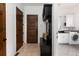 Entryway featuring tile flooring, custom storage bench, and access to the laundry room at 2535 W 115Th Dr, Westminster, CO 80234