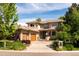 Stately two-story home boasts a well-manicured lawn, mature trees, and a spacious three-car garage at 2535 W 115Th Dr, Westminster, CO 80234