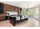 Modern kitchen featuring wood cabinets, granite island with seating, and stainless steel appliances at 2535 W 115Th Dr, Westminster, CO 80234