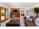 Living room featuring a built-in entertainment center, French doors, and access to an exercise room at 2535 W 115Th Dr, Westminster, CO 80234