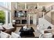 Bright living area featuring a stone fireplace, high ceilings, and an open floor plan at 2535 W 115Th Dr, Westminster, CO 80234