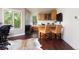 Office space with a bar area, wood cabinets, a cowhide rug, and large windows at 2535 W 115Th Dr, Westminster, CO 80234