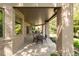 Covered brick patio with an outdoor dining area, providing a serene backyard view at 2535 W 115Th Dr, Westminster, CO 80234