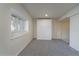 Basement space with a pull-down bed, neutral carpet and a window at 2991 S Zeno Way, Aurora, CO 80013