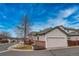 Exterior view of home features a two-car garage and well-maintained landscape at 2991 S Zeno Way, Aurora, CO 80013