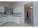 Well-lit kitchen features light granite countertops and leads to adjoining rooms at 2991 S Zeno Way, Aurora, CO 80013