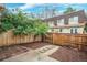 Private fenced backyard with a patio, stepping stones, and landscaping at 7755 E Quincy Ave # T48, Denver, CO 80209