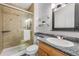 Bathroom with a glass-enclosed shower, granite countertop and decorative mirror at 7755 E Quincy Ave # T48, Denver, CO 80209
