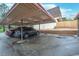 Carport with parking space for two cars, and a brick retaining wall at 7755 E Quincy Ave # T48, Denver, CO 80209