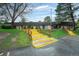 Exterior shot of the property, with mature trees and yellow safety stairs to the entrance at 7755 E Quincy Ave # T48, Denver, CO 80209