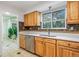 Kitchen with stainless steel appliances, light cabinetry and stone backsplash at 7755 E Quincy Ave # T48, Denver, CO 80209
