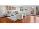 Bright living room features modern furnishings, hardwood floors and access to the outdoors at 7755 E Quincy Ave # T48, Denver, CO 80209
