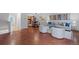Open concept living room flows into dining area with hardwood floors and modern decor at 7755 E Quincy Ave # T48, Denver, CO 80209