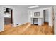 Open dining area with hardwood floors and built-in mini-fridge at 749 Poplar St, Denver, CO 80220