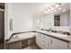 Bright bathroom featuring a soaking tub and double vanity with modern finishes and ample counter space at 1522 Willow St, Denver, CO 80220