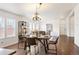 Inviting dining room featuring hardwood floors, a modern chandelier, and ample natural light at 1522 Willow St, Denver, CO 80220
