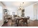 Bright dining area open to the living room, features hardwood floors, a modern chandelier, and ample light at 1522 Willow St, Denver, CO 80220