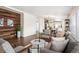 Bright living room boasts modern wood accent wall, hardwood floors, and comfortable seating area at 1522 Willow St, Denver, CO 80220