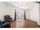 Cozy room with hardwood floors, a leather chair, and sliding glass doors leading to the outdoor area at 1522 Willow St, Denver, CO 80220