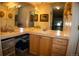 Well-lit bathroom with a spacious vanity and multiple mirrors at 9263 E Arbor Cir # B, Englewood, CO 80111