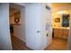 Hallway view of a well-lit bathroom with a washer and dryer closet at 9263 E Arbor Cir # B, Englewood, CO 80111